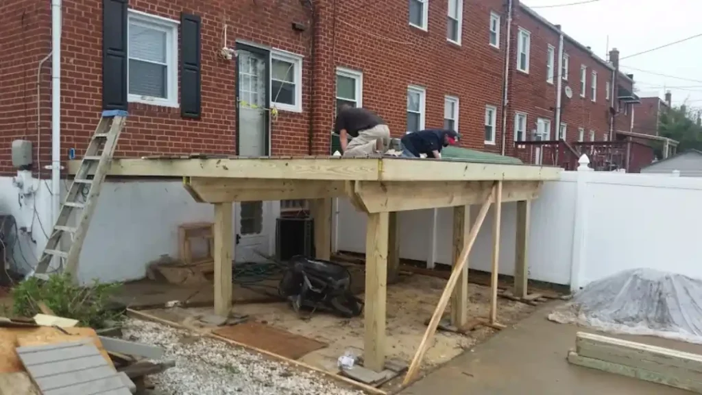 MSD Contractors - Elevated wood deck frame construction at the back of a brick townhouse